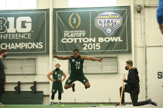 Antjuan Simmons (34) goes through drills as Ryan Armour (47) watches during Michigan State football's pro day March 24, 2021.