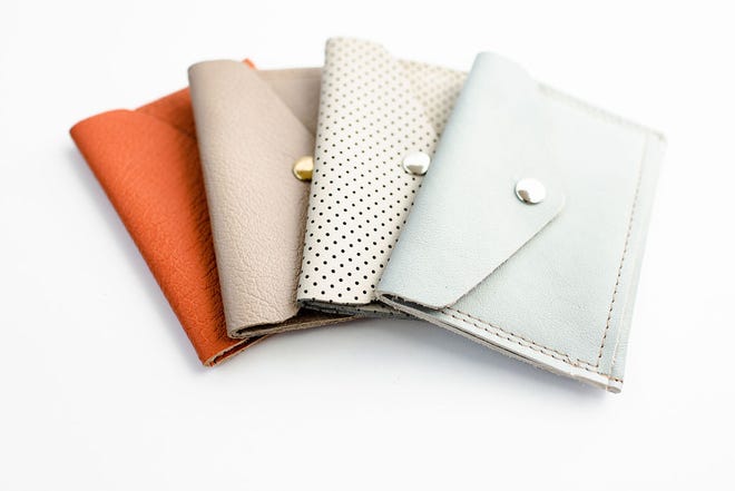 Leather wallets like the ones made by Mend on the Move, will be the kind of product the Detroit nonprofit will manufacture with thousands of dollars in car seat leather donated by Ford Motor Co. leather goods will benefit abuse survivors.