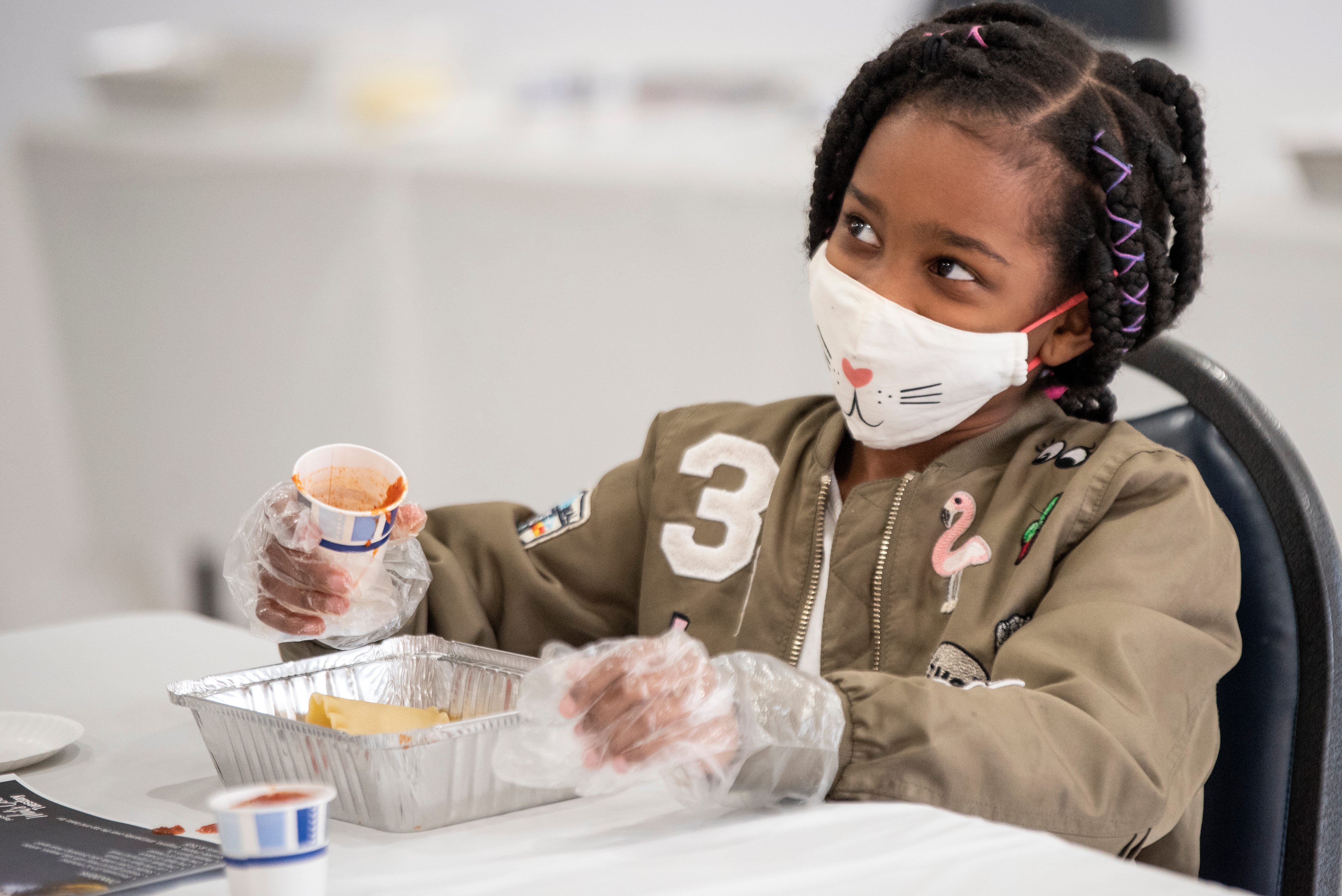 The Passaic Recreation Department offers a program called 'What’s Cookin’ Tuesdays.' The class teaches children from ages 6-10 how to prepare healthy meals while socializing with other children. Gianna Williams, 8, pours sauce on her lasagna on Tuesday March 23, 2021.