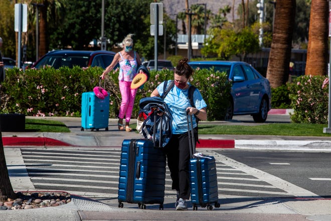 Travelers arrive and depart the Palm Springs International Airport in Palm Springs, Calif., on March 24, 2021. 