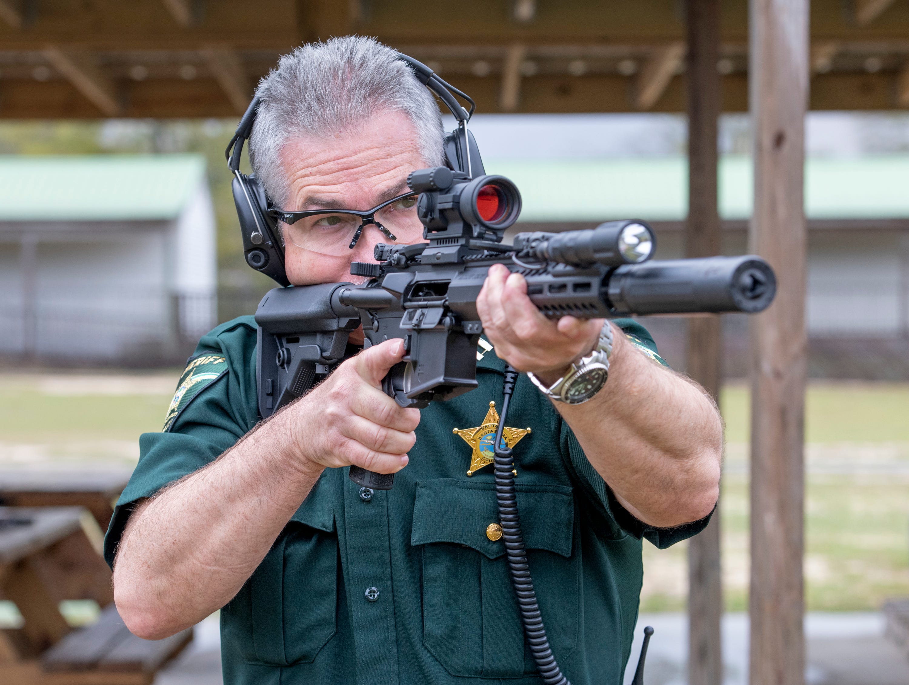 Santa Rosa County Sheriff Bob Johnson talks about the new AR-15 rifles  purchased for all deputies; Capt. Blevin Davis demonstrates the firearm.  Gregg Pachkowski, Pensacola News Journal