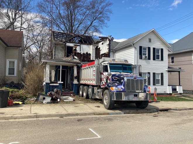 Crews from Lehotay Trucking and Excavating are razing an abandoned residence on North Eighth Street in Cambridge for the Guernsey County Land Bank. Workers were tearing down the structure by hand due to the close proximity of the neighboring homes.