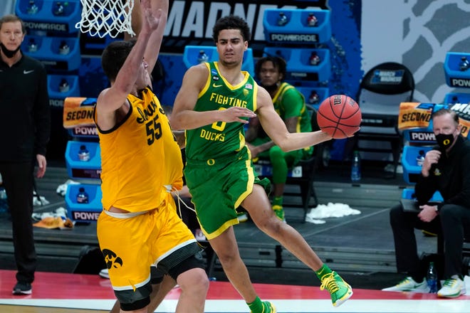 Oregon guard Will Richardson drives on Iowa center Luka Garza (55) during the second half of the Ducks' 95-80 win over the Hawkeyes during Monday's second-round game in the NCAA Tournament.