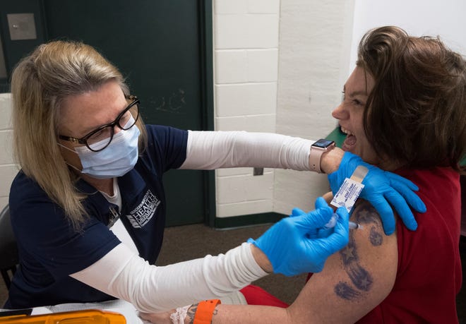Shayla Alvey-Williams, an inmate at the Vanderburgh County Jail, receives her dose of the Johnson & Johnson COVID-19 vaccine from Vanderburgh County Health Department employee Cathy Head Thursday afternoon, March 25, 2021. VCHD allocated 125 doses of the one-shot Johnson & Johnson vaccine for inmates.