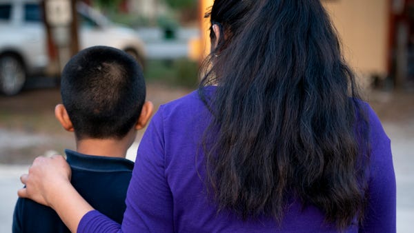 Juliana poses for a photo with her two sons in Imm