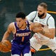 Phoenix Suns guard Devin Booker (1) looks for way around Orlando Magic guard Evan Fournier, right, during the first half of an NBA basketball game, Wednesday, March 24, 2021, in Orlando, Fla. (AP Photo/John Raoux)