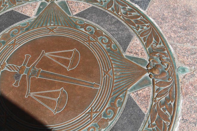 A detail of the plaque in the floor outside of the entrance of Superior Court.