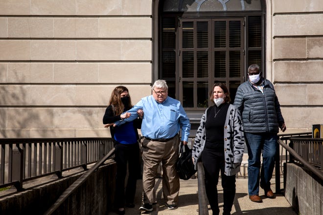 Former Portsmouth city councilman and lawyer Michael Mearan leaves Scioto County Courthouse with his daughters on Friday, March 26, 2021, in Portsmouth, Ohio.  Judge Patricia Cosgrove ordered Mearan to house arrest. Mearan is charged with 18 counts spanning human trafficking, racketeering and compelling and promoting prostitution. He has consistently denied the allegations.