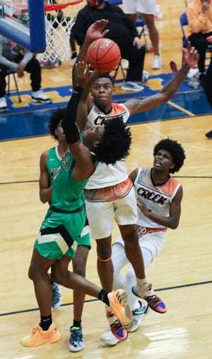 Fern Creek's CeArius Warren (4) blocked a shot by Western's Jahnoi Lee (10) during their game at Valley High School in Louisville, Ky. on Mar. 25, 2021.
