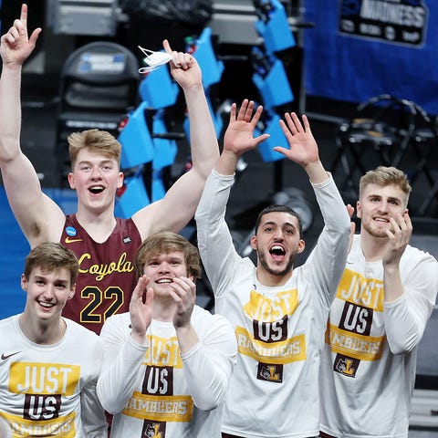 The Loyola Ramblers point to Sister Jean after def