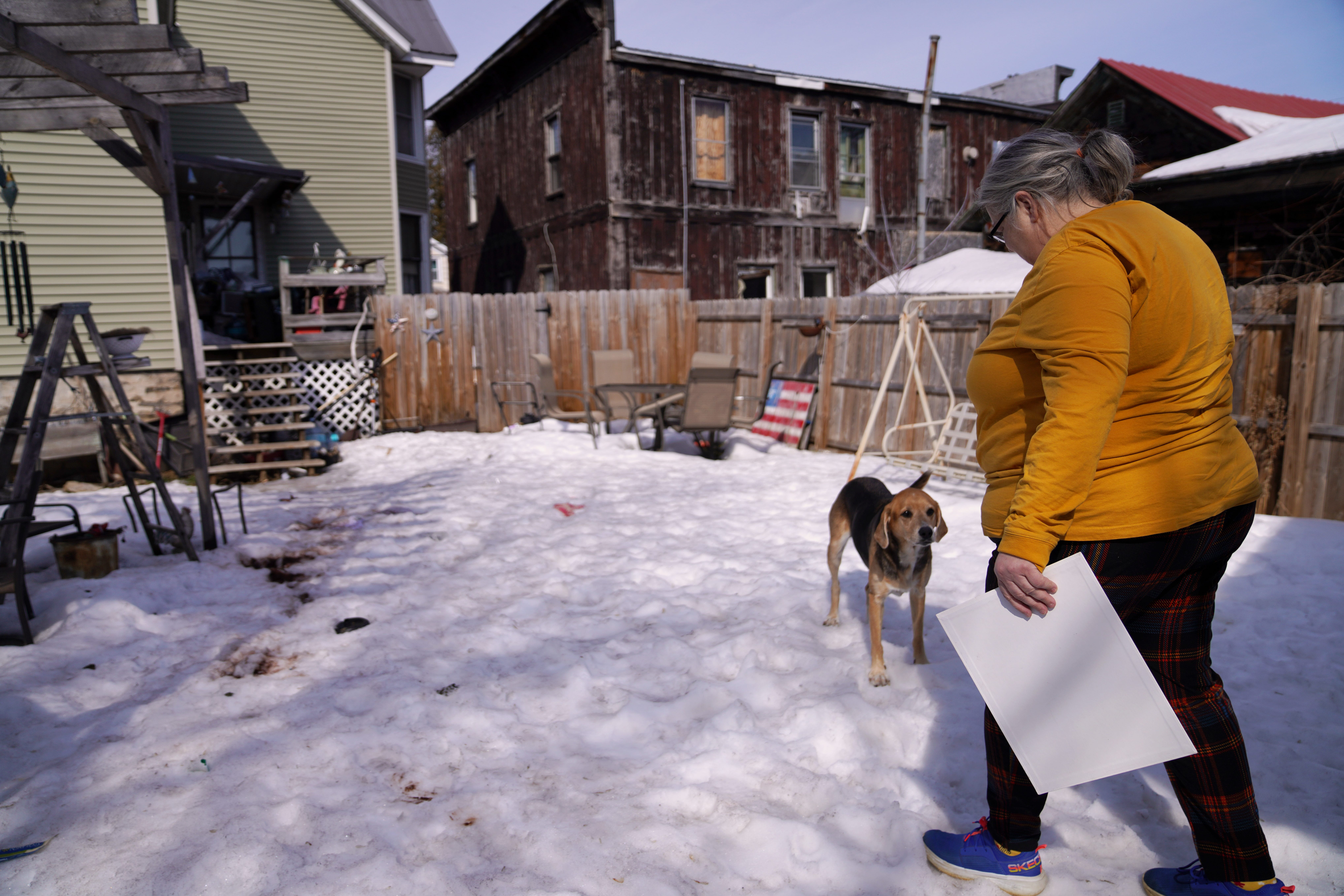 Carrie Demers tends to some chores in the yard of her home in Ogdensburg.