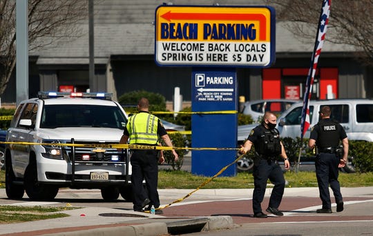 Virginia Beach police put up police tape across Pacific Ave. at the Oceanfront on Saturday, March 27, 2021, morning after a fatal shooting the night before in Virginia Beach, Va.