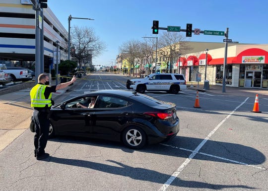 Virginia Beach police redirect traffic on Saturday, March 27, 2021 after late night shootings as they investigate a late night shooting in Virginia Beach, Va.