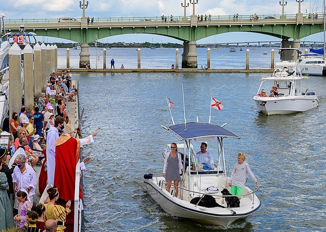Bishop Felipe Estevez blesses a passing boat at the St. Augustine Municipal Marina during the annual Blessing of the Fleet celebration on Sunday. Every year on Palm Sunday the Bishop from the Catholic Diocese of St. Augustine blesses vessels with holy water after a processional from the cathedral in a tradition that dates back to colonial times.