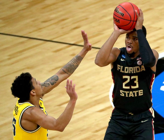 Florida State Seminoles guard M.J. Walker (23) shoots over  a Michigan defender during the Sweet Sixteen round of the 2021 NCAA Tournament on Sunday, March 28, 2021, at Bankers Life Fieldhouse in Indianapolis, Ind.