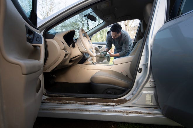 Edison Lozano works to clean out his flood damaged car outside his home on W. Durrertt Dr. Sunday, March 28, 2021 in Nashville, Tenn. Flash flooding along Sevenmile Creek the night before caused major damage in the South Nashville neighborhood. 
