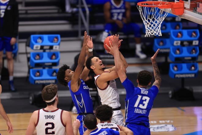 Gonzaga guard Jalen Suggs drives to the basket against Creighton forward Christian Bishop (13) during the Sweet 16 of the 2021 NCAA Tournament at Hinkle Fieldhouse.