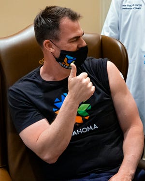 Gov. Kevin Stitt reacts after he receives his Johnson and Johnson COVID-19 vaccine from the Oklahoma State Department of Health at the Oklahoma state Capitol in Oklahoma City, Okla on Monday, March 29, 2021.