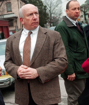 Providence police Detectives Stephen Springer, center, and Sgt. Vincent Mansolillo investigate on Elmwood Avenue in Providence in 2002.