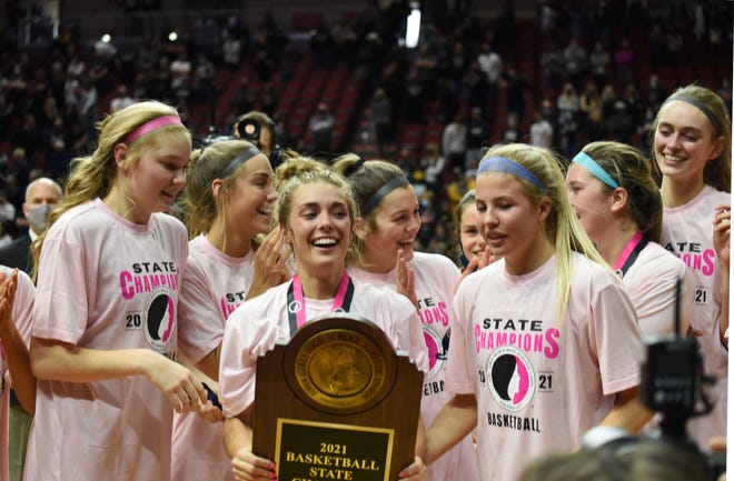 Molly Ihle (with trophy) and Josie Fleischmann (front right) led the Ballard girls' basketball team to the Class 4A state championship in 2020-2021. The Bombers went 24-1 to claim the second state title in school history.