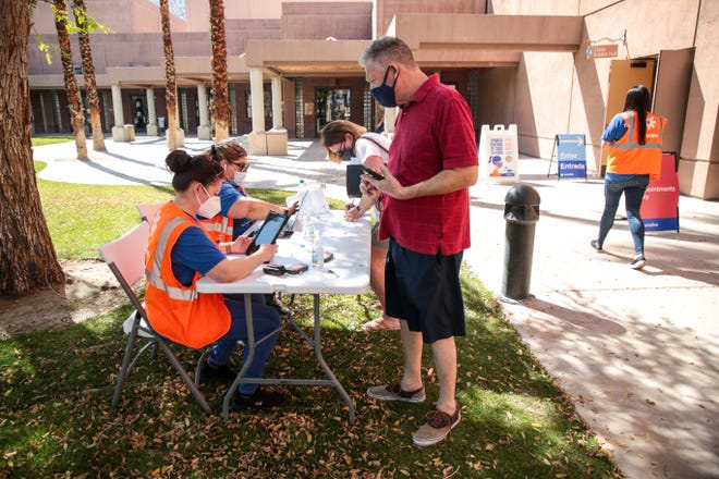 Curative employees register people to receive the COVID-19 vaccine on Monday, March 29, 2021, at the Palm Springs Convention Center. The vaccination site is no longer operating.