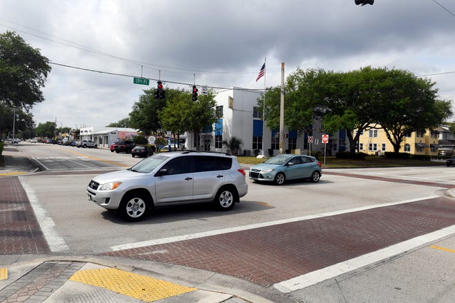 Cars pass through the intersection of State Road 60 and 14th Avenue on Monday, March 29, 2021, in downtown Vero Beach. The city is considering reducing the number of lanes on State Road 60 through downtown to slow traffic in the interest of pedestrian safety.
