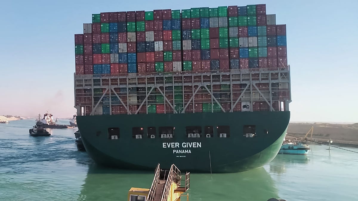 This picture taken on March 29, 2021 from a nearby tugboat in the Suez Canal shows a view of the Panama-flagged MV 'Ever Given' (operated by Taiwan-based Evergreen Marine) container ship as it begins to move.