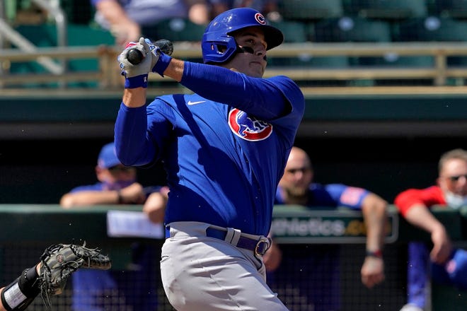 Chicago Cubs' Anthony Rizzo follows through on a base hit during the first inning of a spring training baseball game against the Oakland Athletics, Friday, March 19, 2021, in Mesa, Ariz. [AP Photo/Matt York]