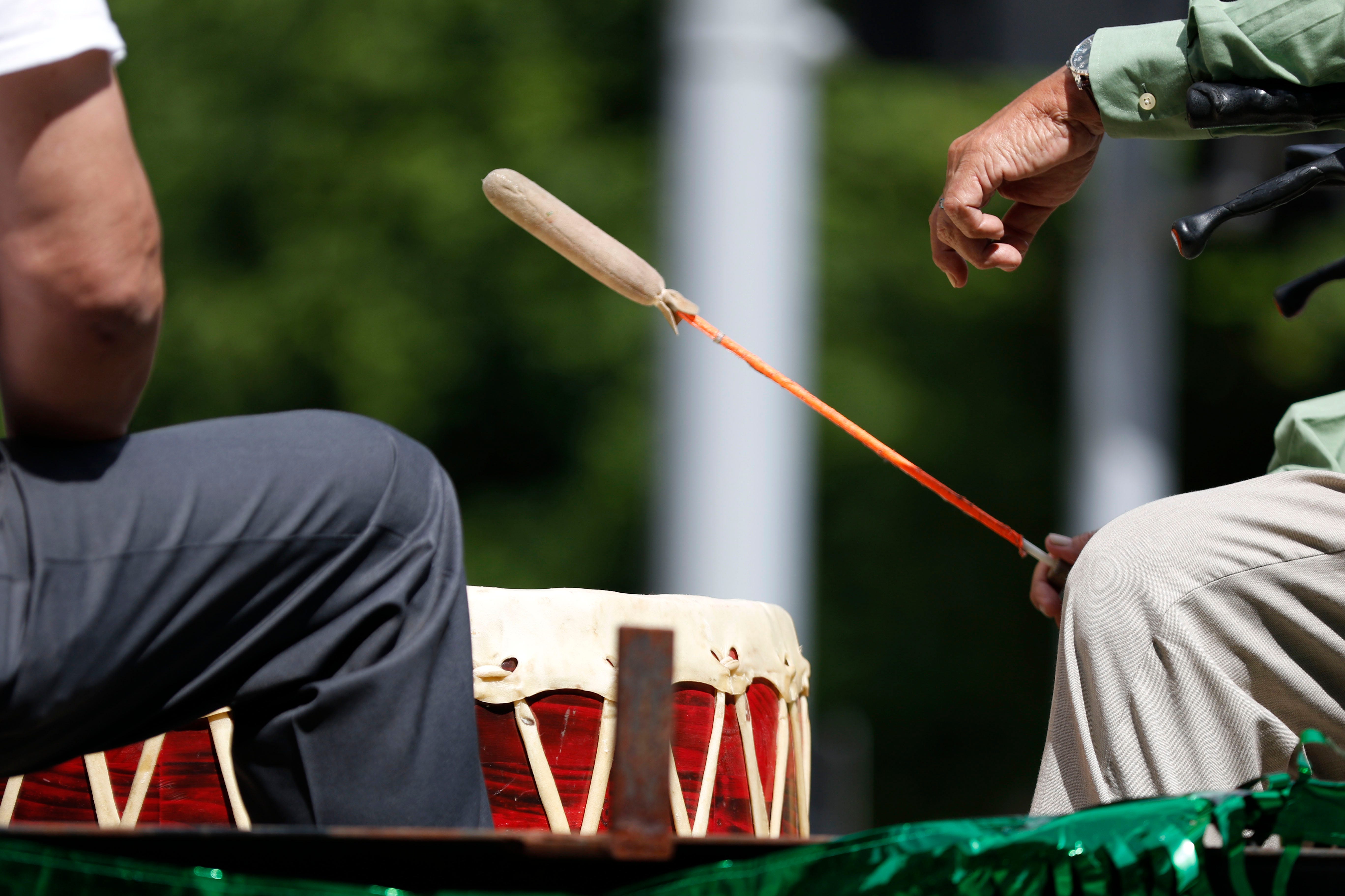 A member of the Oklahoma City Pow-Wow Club hits a drum during the parade for the 2019 Red Earth Festival in downtown Oklahoma City.