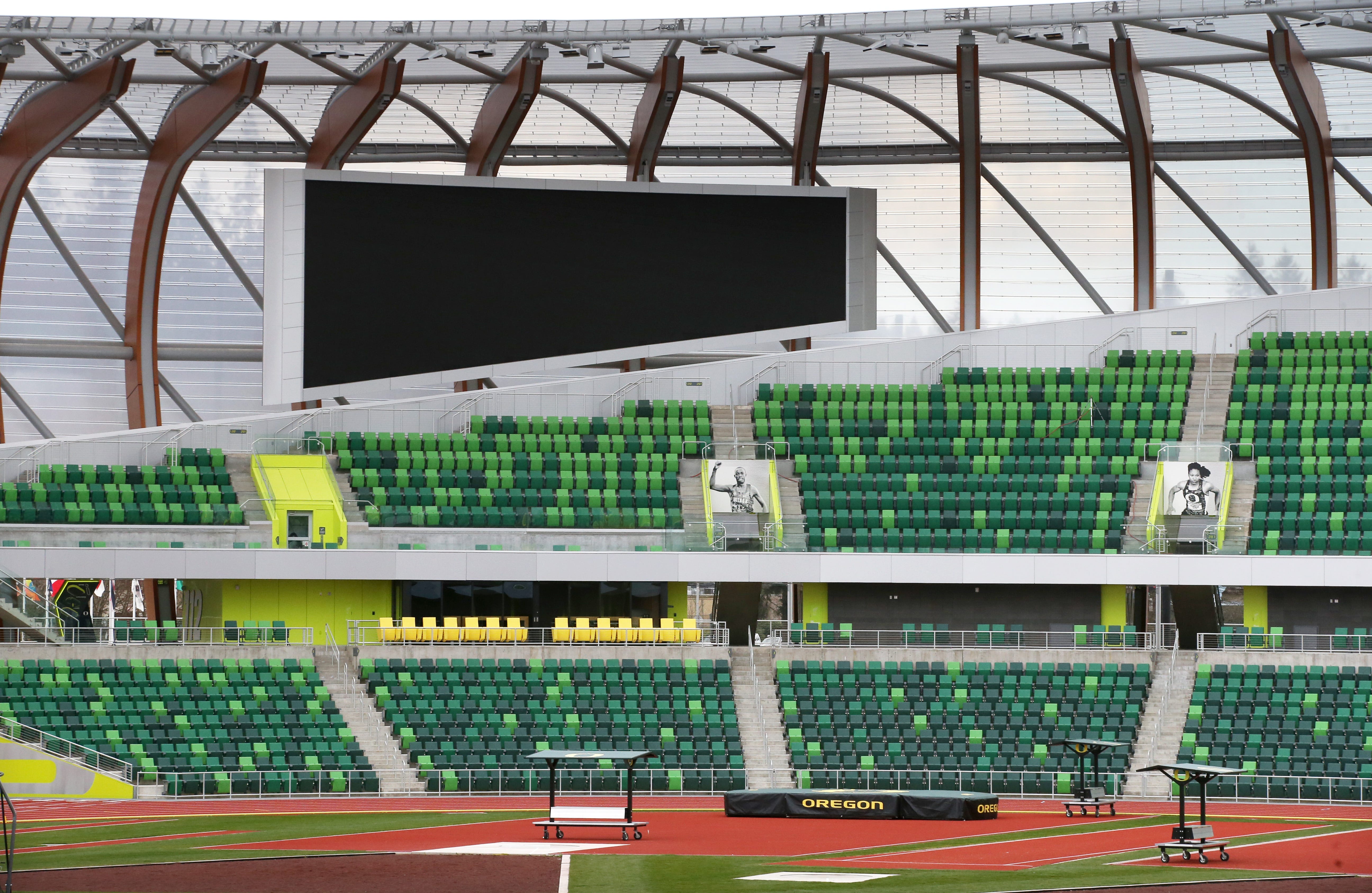 Large video screens hang over then seating areas in turns two and four at Hayward Field  in Eugene, Oregon, on March 29, 2021.