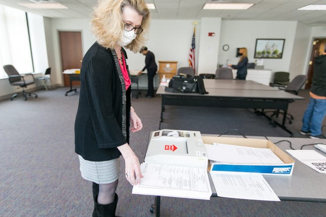 Winnebago County Clerk Lori Gummow tests the optical scanning AccuVote machines at Winnebago County Administrative Building Tuesday, March 30, 2021, in Rockford, with a test deck of ballots to confirm machines accurately count and record ballots ahead of the April 6 election.