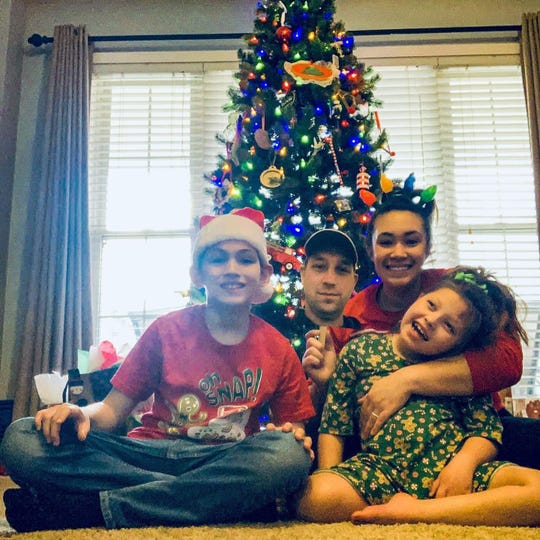 Army spouse Jordan Hammond poses with her two children and "Dad on a stick" at Christmas. The Hammonds are one of many Montgomery County military families who've been forced to deal with a deployment on top of the COVID-19 pandemic.