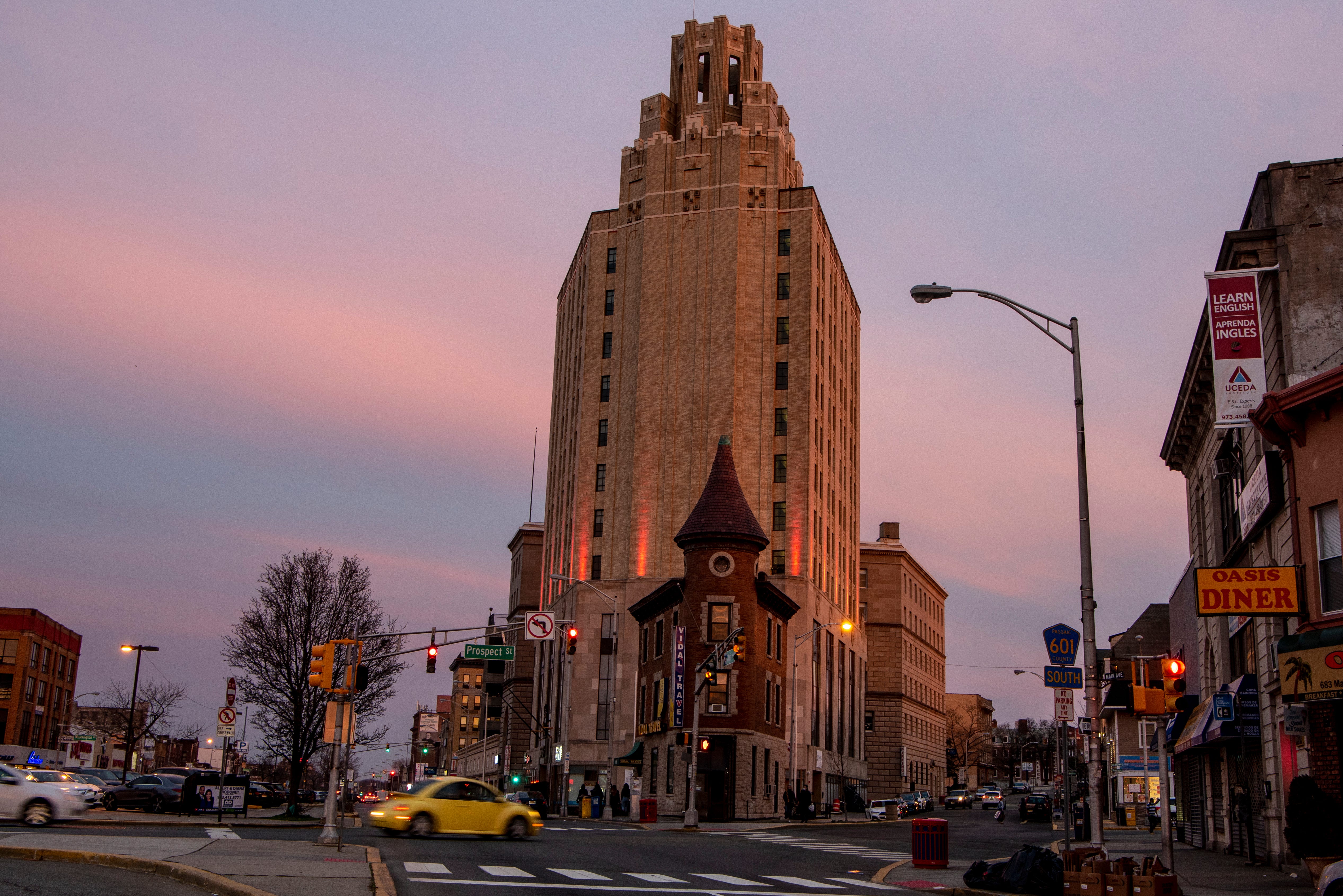As the sun sets, the clouds turn the color of cotton candy behind the 11-story Art Deco building that sits at 663 Main Ave. The building was originally a bank when it opened in 1931, but now houses a Blink gym.