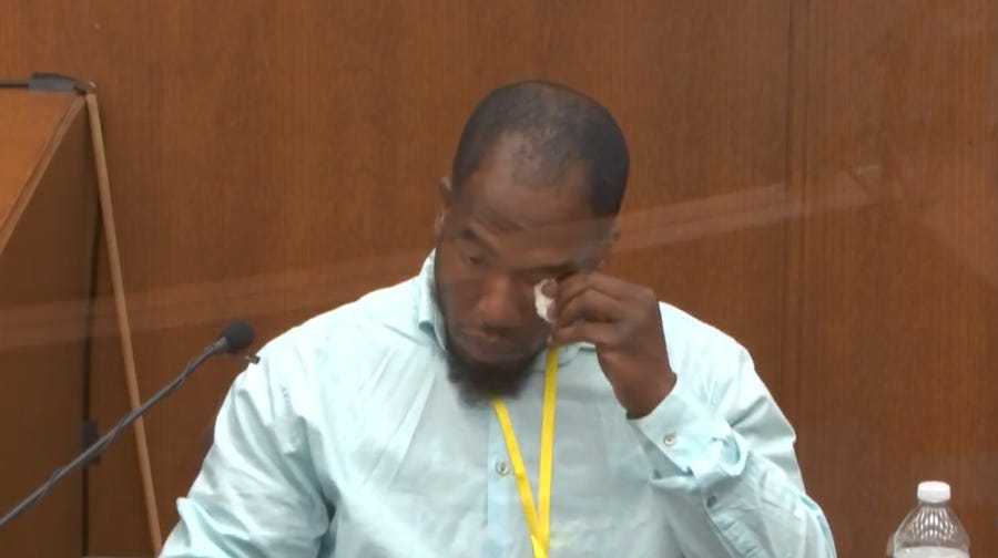 In this image from video, witness Donald Williams wipes his eyes as he answers questions, as Hennepin County Judge Peter Cahill presides Tuesday, March 30, 2021, in the trial of former Minneapolis police officer Derek Chauvin at the Hennepin County Courthouse in Minneapolis, Minn.   Chauvin is charged in the May 25, 2020 death of George Floyd.  (Court TV via AP, Pool) ORG XMIT: CER203