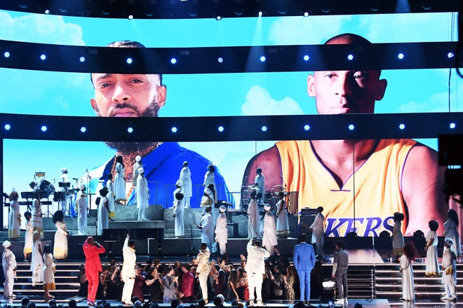 Images for the late Nipsey Hussle and Kobe Bryant are projected onto a screen while YG, John Legend, Kirk Franklin, DJ Khaled, Meek Mill, and Roddy Ricch perform onstage during the 62nd Annual GRAMMY Awards at STAPLES Center on January 26, 2020 in Los Angeles, California.