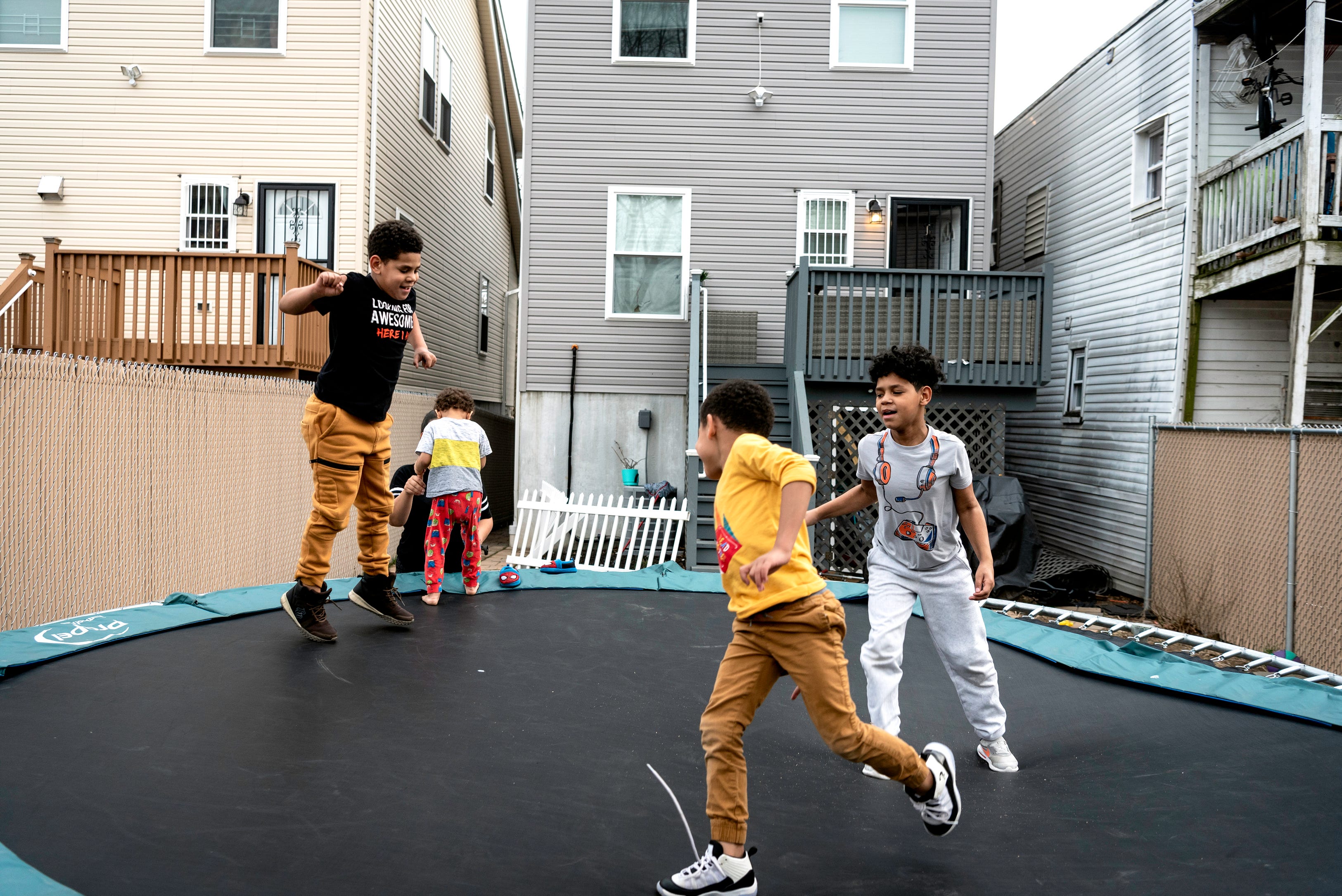 The De La Cruz brothers, Israel, 8, Benjamin, 5, and Raylin, 10, blow off steam after a day of remote learning in the backyard of their Hamilton Ave. home in Paterson. Dafani Peralta and Ramon De La Cruz and their six children, moved into their new home on 185 Hamilton Ave. in Paterson last year. The home is part of the "Hamilton 7," a group of seven Habitat for Humanity homes built on the block.