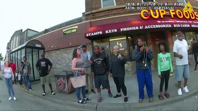 This image from a police body camera shows people gathering as former Minneapolis police officer Derek Chauvin was recorded pressing his knee on George Floyd's neck for several minutes as onlookers yelled at Chauvin to get off and Floyd saying that he couldn't breathe on May 25, 2020 in Minneapolis.