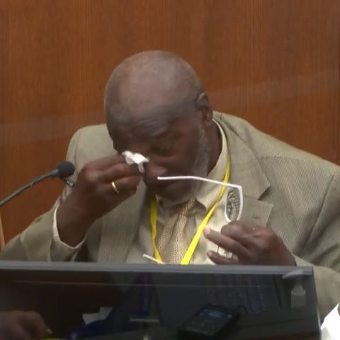 Witness Charles McMillian becomes emotional as he 