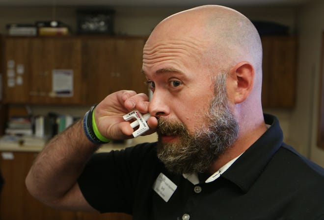 Seth Dewey, Reno County Health Department’s Substance Misuse Health Educator, shows how the Narcan nasal spray is administered to a person who has overdosed. He emphasized that even if Narcan is used, 911 should still be called and seek medical attention because the spray wears off after about 30 minutes and the person could go back into overdose.