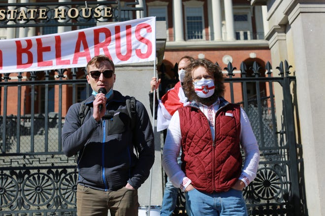 During the rally to mark Belarusian Freedom Day in Boston, Nikolai Makaranka, left, read a letter to U.S. Rep. Bill Keating, which was further signed by the rally participants.