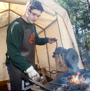 Nicholas Riolo, 17, of Bellingham, works in his blacksmith shop in the backyard of his family's house.