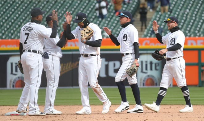 The Tigers high-five one another after the 3-2 win over the Indians on Opening Day on Thursday, April 1, 2021, at Comerica Park.