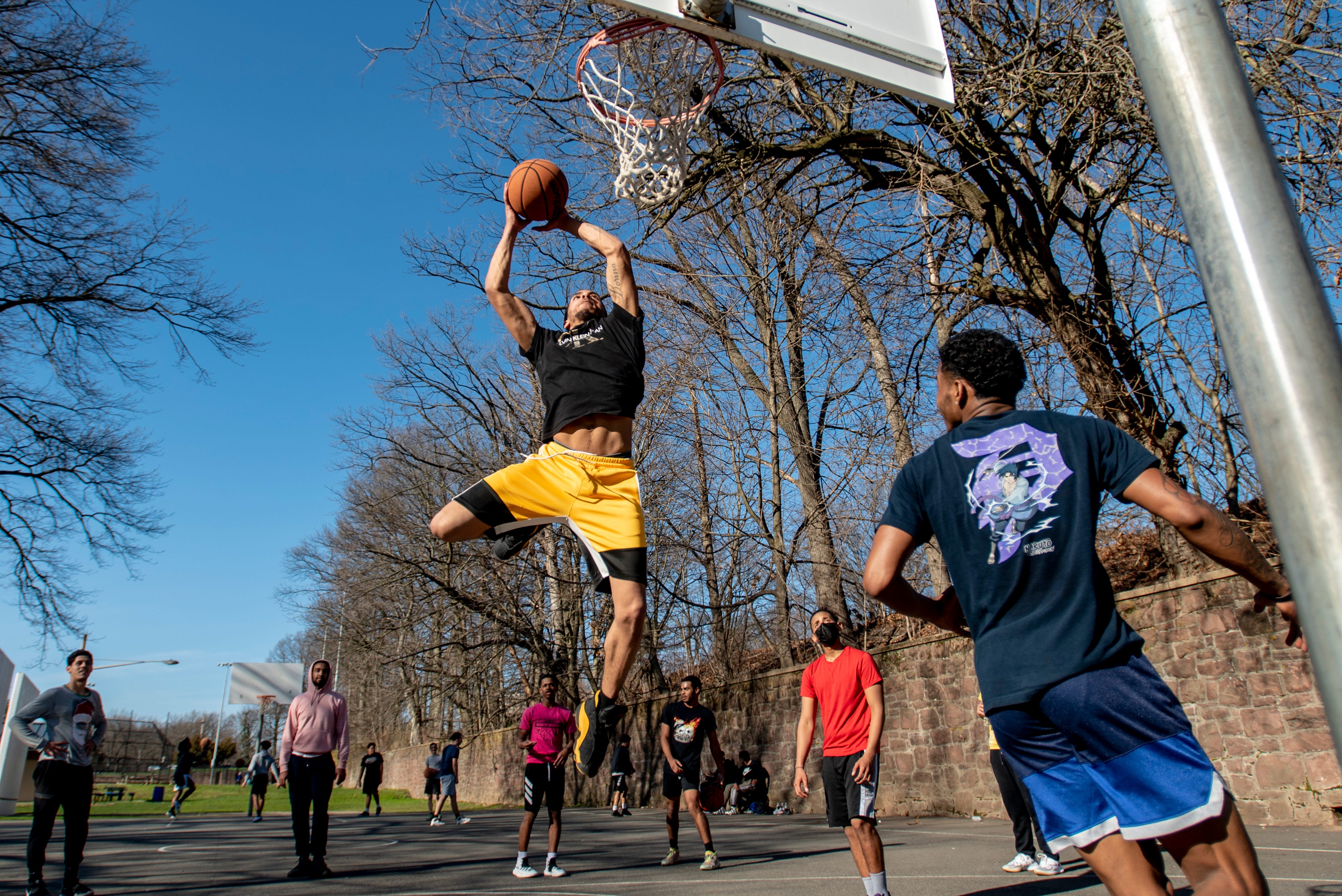 Anthony Rodriguez warms up before he plays basketball at the courts on Passaic Avenue in Passaic on Tuesday, March 30, 2021.