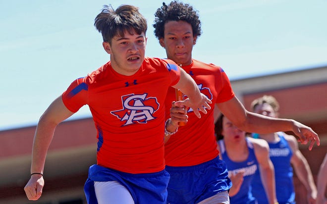 Andres Diaz, left, and Jordan Weatherspoon, right, compete in a relay event for Central during the District 2-6A track meet in San Angelo on Thursday, April 1, 2021.