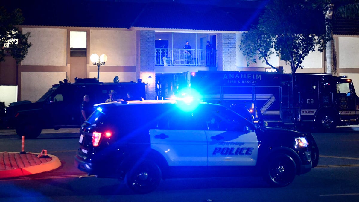 Police officers had trouble getting into a building where four people, including a child, were killed in a shooting in Orange, Calif.