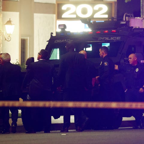Police officers stand outside an office building w