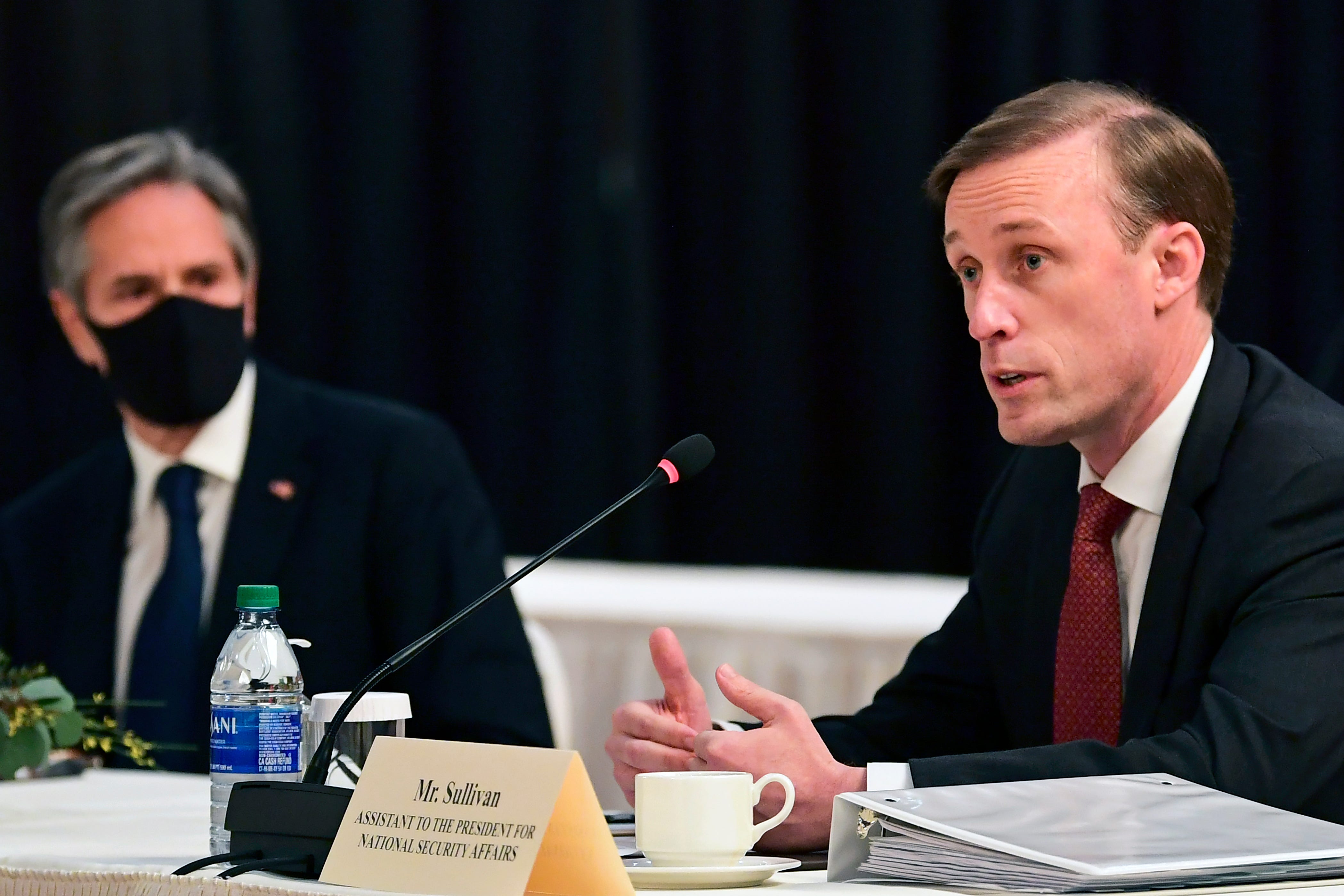 Secretary of State Antony Blinken, left, listens as White House national security adviser Jake Sullivan, right, speaks at the opening session of U.S.-China talks at the Captain Cook Hotel in Anchorage, Alaska, on March 18.