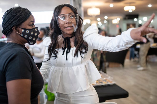 Renee Nesbitt, owner of Building Bosses Boutique talks to Bonnie Ferrell at her pop-up shop on the west side of Detroit on March 13, 2021.