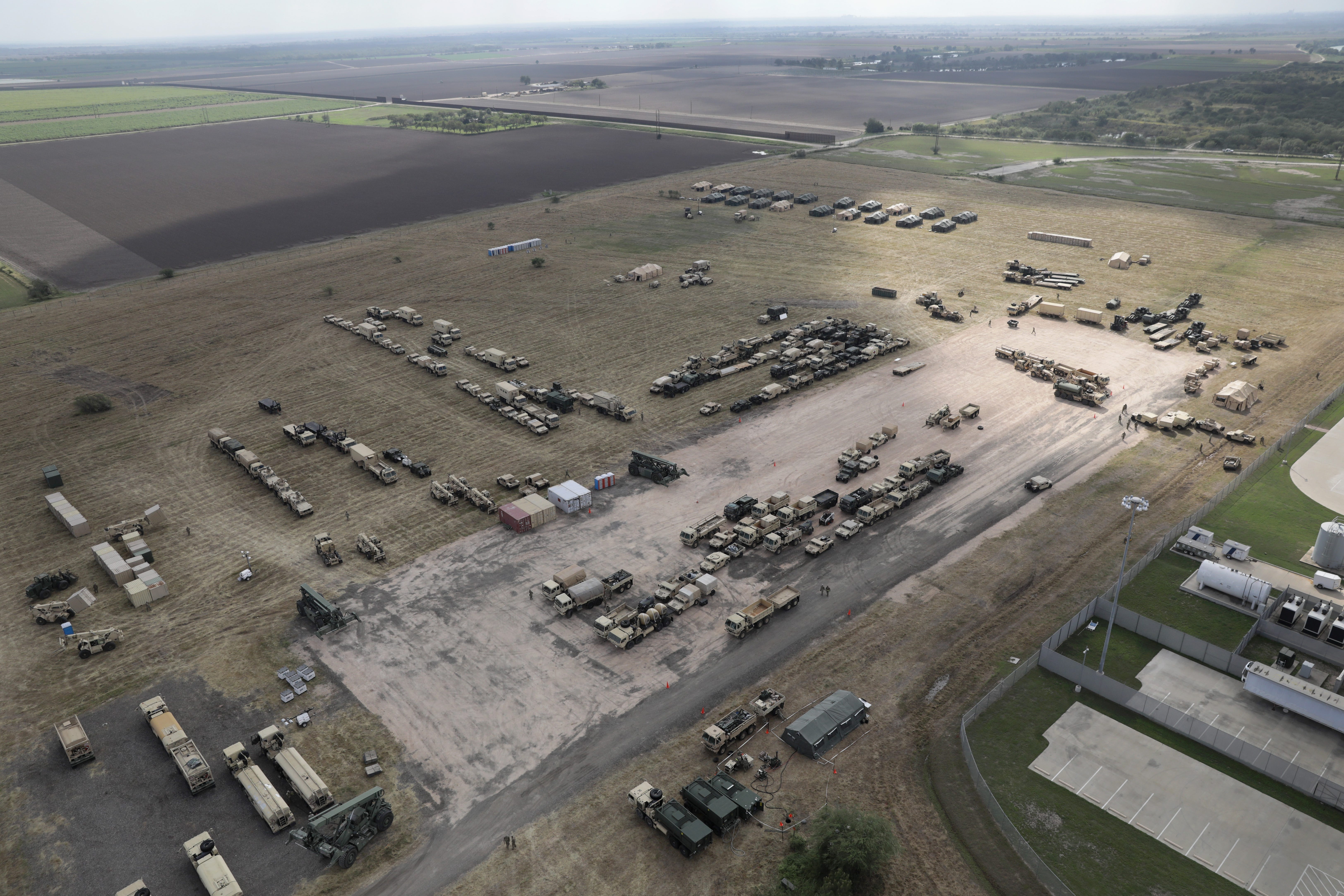 U.S. Army vehicles sit at a military camp under construction at the U.S.-Mexico border on November 7, 2018 in Donna, Texas. The forward operating base is located near the Donna-Rio Bravo International Bridge and port of entry between the United States and Mexico. U.S. President Donald Trump ordered troops to the border weeks in advance of the possible arrival of a migrant caravan, which the president has called an "invasion." (Photo by John Moore/Getty Images)