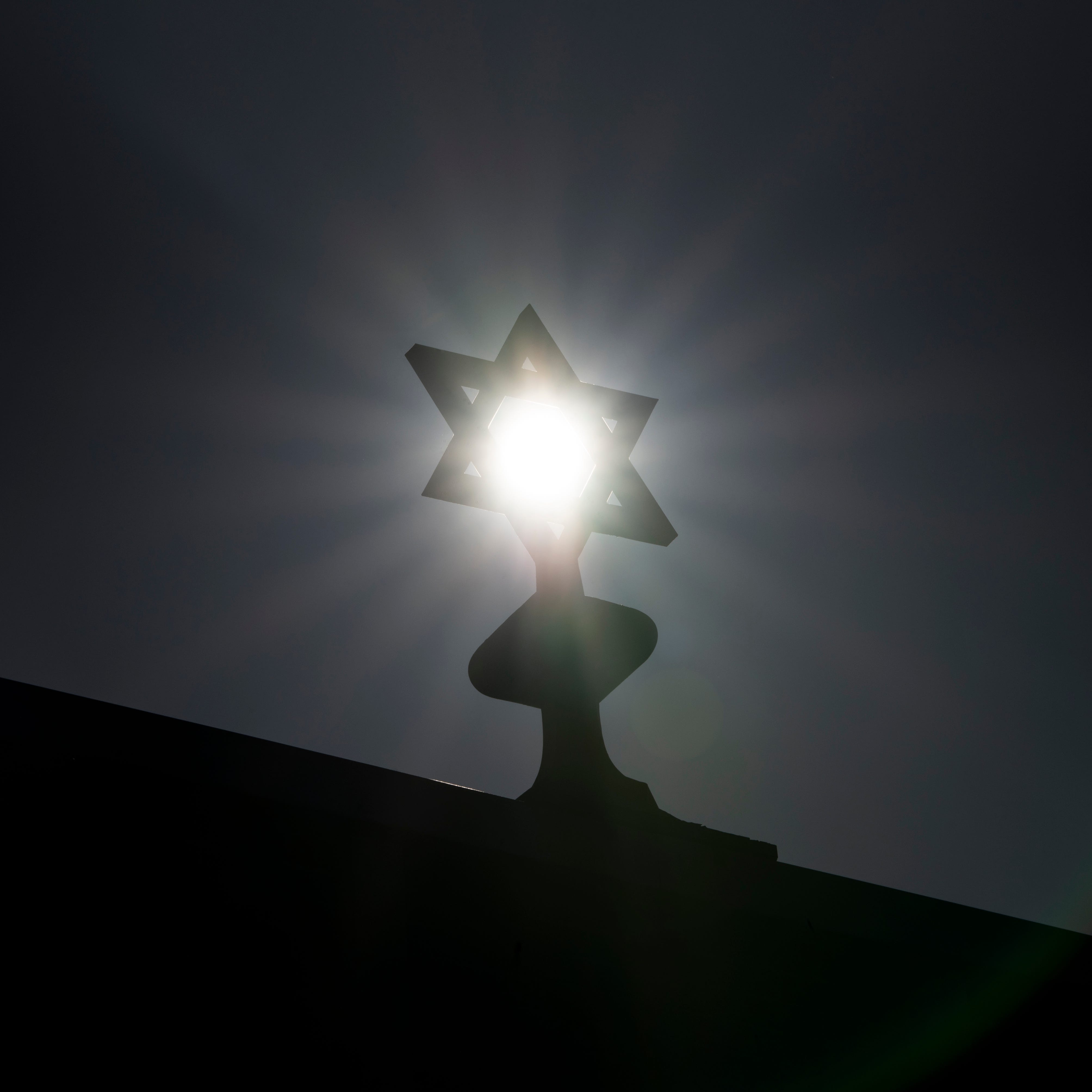 The sun shines through the Star of David on top of the Congregation Ahavas Israel on Van Houten Avenue in Passaic on Saturday, April 3, 2021. Passaic has a large Orthodox Jewish community and houses about 20 Orthodox synagogues.